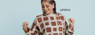 Woman wearing a patterned sweater and denim shorts on a light blue background with 'artera' branding.